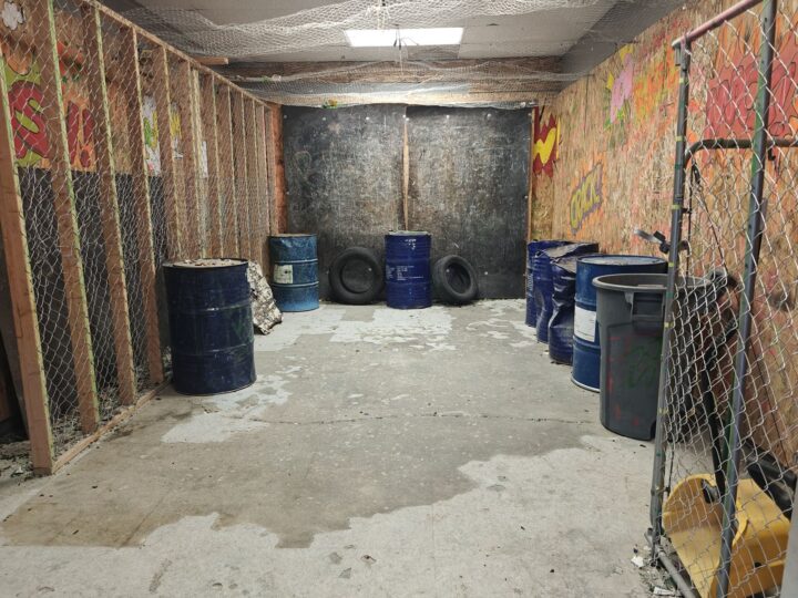 An empty Ragescape rage room with barrels and tires, ready for the next session